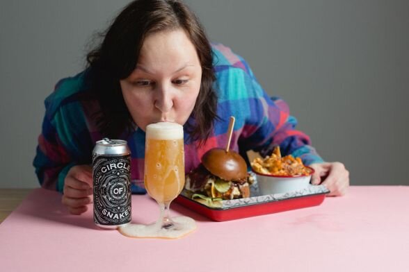 Jules pictured with a Hop Hideout beer and some food from Kommune’s Fat Hippo. [Permission granted by Jules Gray to share image]