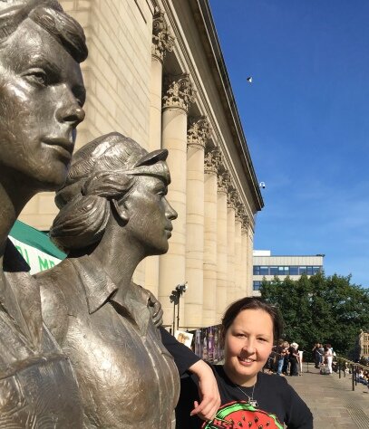 Jules pictured next to the Women of Steel statue in the city centre, near the City Hall. [Permission granted by Jules Gray to share image]